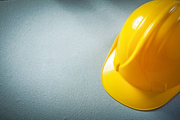 Hard hat on concrete background construction concept