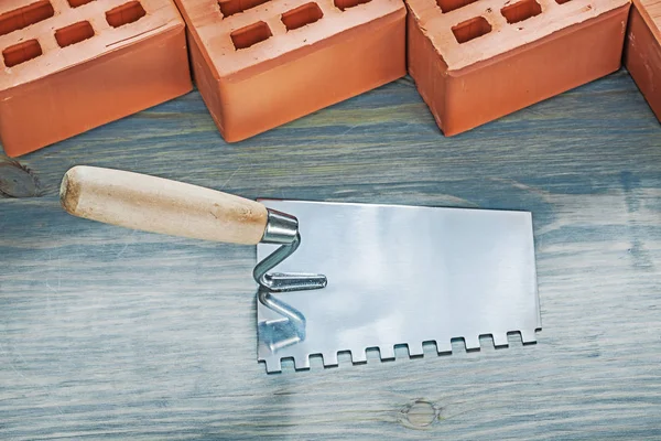 Red bricks construction spatula on wood board bricklaying concep — Stock Photo, Image