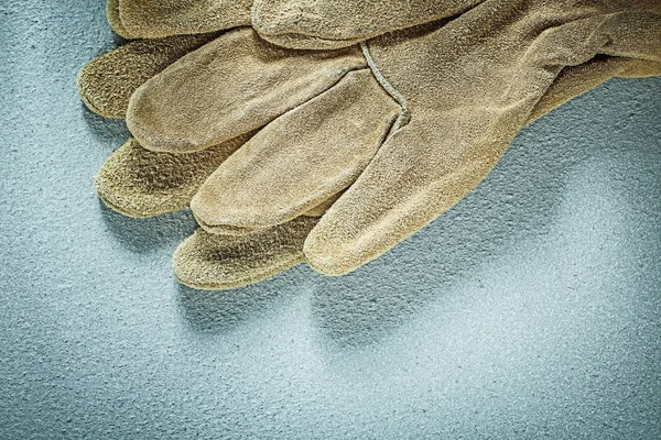 Protective gloves on concrete surface construction concept