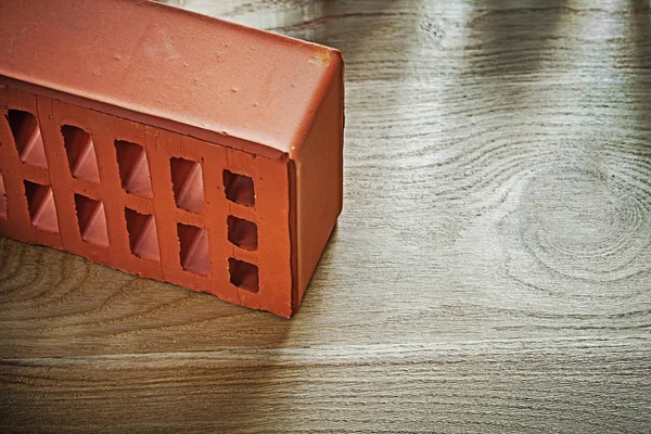 Red building brick on wooden board construction concept — Stock Photo, Image