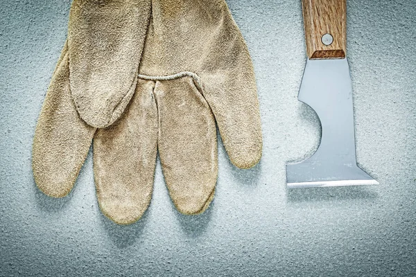 Construction spatula safety gloves on concrete surface building