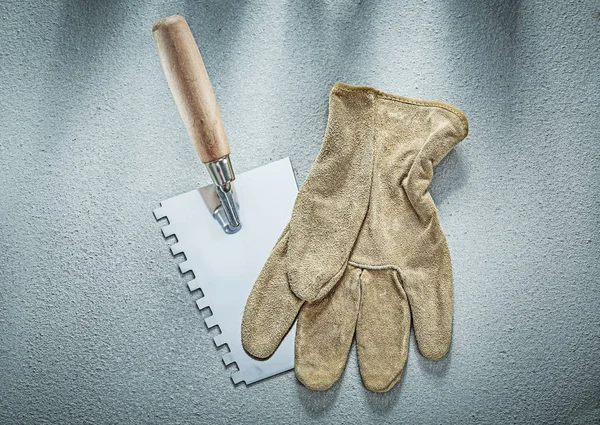 Paint scraper safety gloves on concrete surface construction con