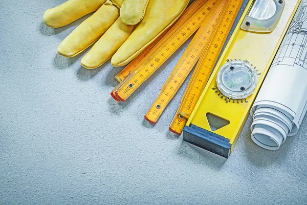 Schutzhandschuhe Konstruktion Ebene hölzerne Meter Baupläne auf conc — Stockfoto