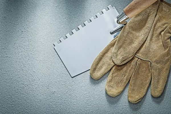 Paint scraper leather protective gloves on concrete background c