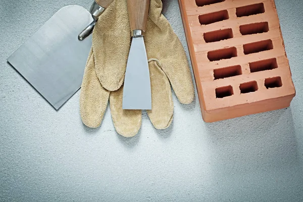 Construction brick protective gloves paint scrapers on concrete