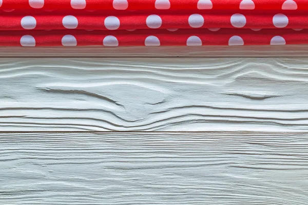 Red table cloth on wooden board