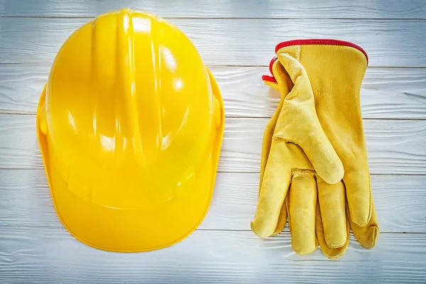 Building helmet leather protective gloves on white board — Stock Photo, Image