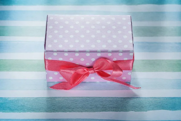 Pink present box on blue striped fabric top view holidays concep — Stock Photo, Image