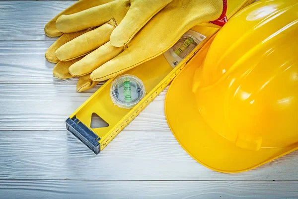 Hard hat safety gloves construction level on white board — Stock Photo, Image