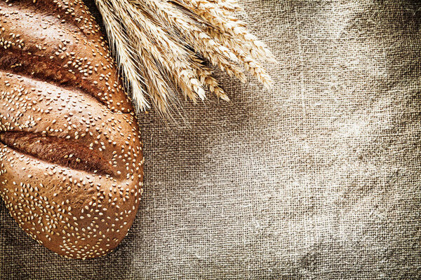 Wheat ears bread on sacking background