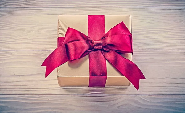 Wrapped present box on wooden board directly above holidays conc — Stock Photo, Image