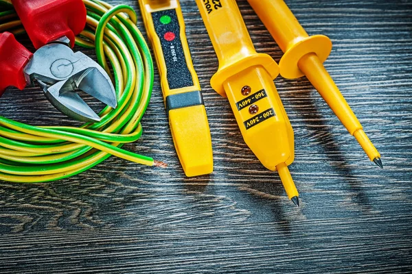 Electric tester nippers rolled wire on wooden board — Stock Photo, Image