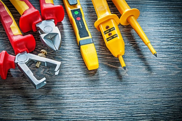 Electric tester nippers insulated strippers on wooden board — Stock Photo, Image