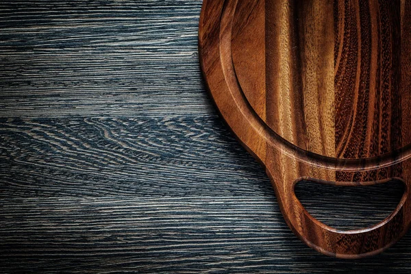 Cutting board on wood background — Stock Photo, Image