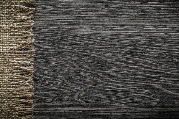 Vintage burlap cloth on wooden board