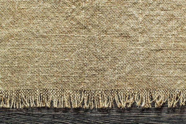 Вінтажна міцна тканина на дерев'яній дошці — стокове фото