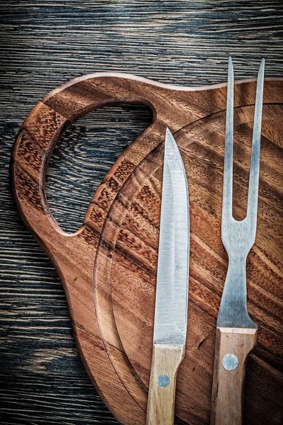 Meat fork knife wooden carving board on wood background — Stock Photo, Image