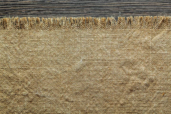 Vintage bagging textile on wooden board