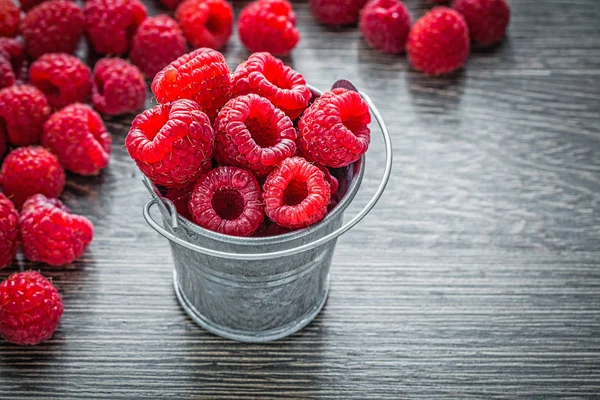 Red raspberries in basket on wooden board — Stock Photo, Image