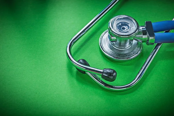 Medical stethoscope for checkup on green background — Stock Photo, Image