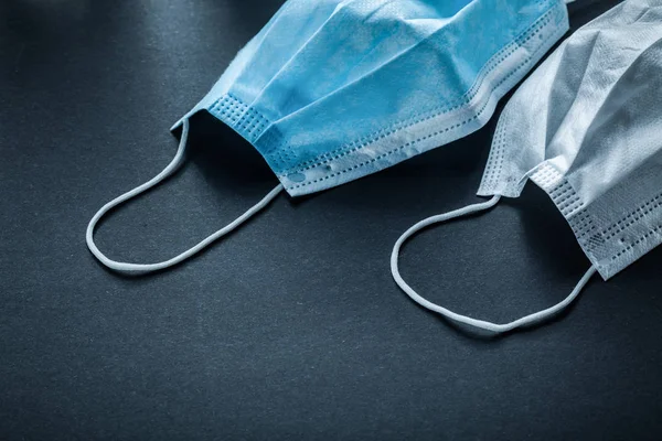 Disposable protective face mask on black background — Stock Photo, Image