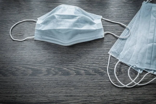 Set of medical disposable face masks on vintage wooden board — Stock Photo, Image