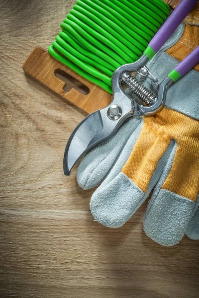 Garden pruner garden soft twist tie safety gloves on wooden boar — Stock Photo, Image