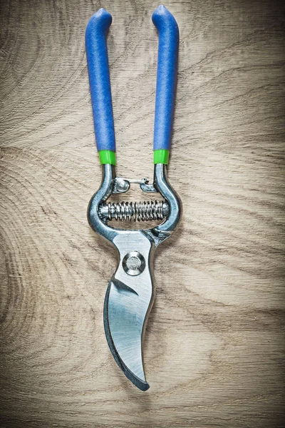 Sharp pruning shears on wooden board — Stock Photo, Image