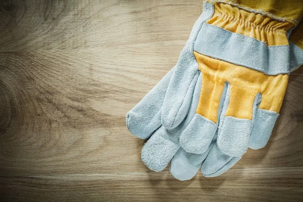 Guantes de seguridad sobre tabla de madera —  Fotos de Stock