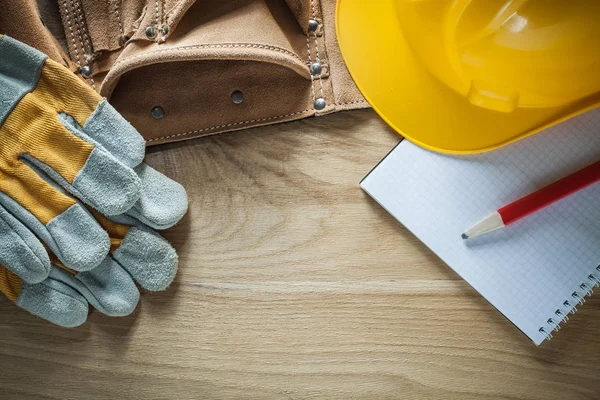 Leather tool belt safety gloves hard hat notebook pencil — Stock Photo, Image