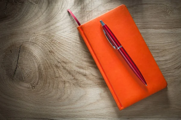 Orange notebook pen top view
