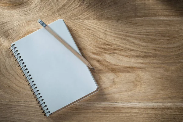 Vintage spiral notepad pencil on wooden board top view — Stock Photo, Image