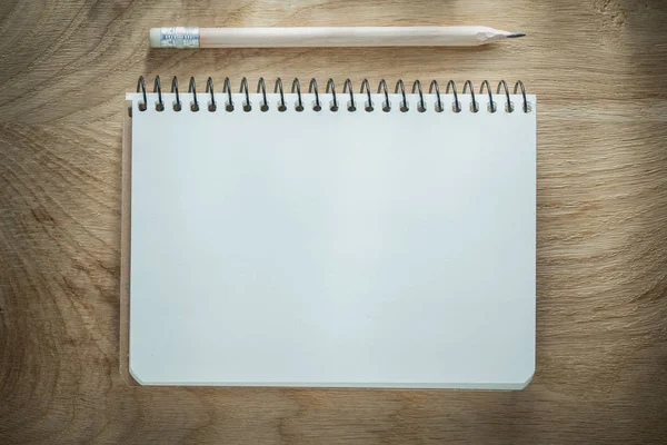 Opened notepad pencil on wooden board — Stock Photo, Image