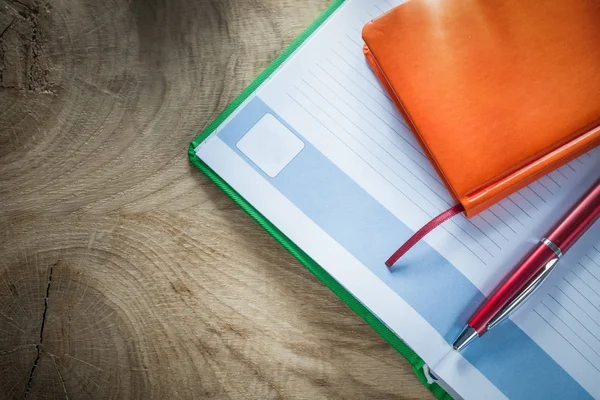 Notebooks ballpoint pen on wooden board — Stock Photo, Image