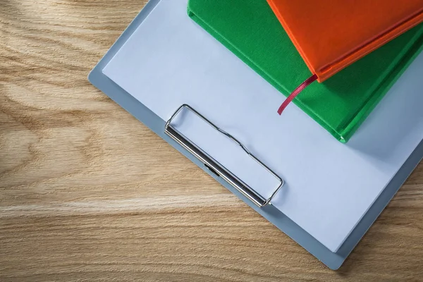 Clipboard blank paper notebooks on wooden board — Stock Photo, Image