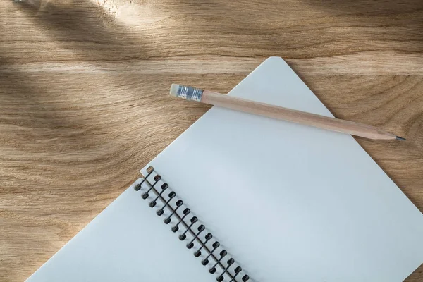 Vintage spiral copybook pencil on wooden board top view — Stock Photo, Image