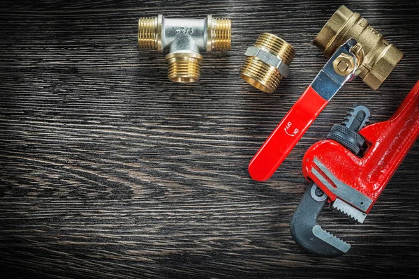 Plumbing monkey wrench connectors water valve on vintage wooden — Stock Photo, Image