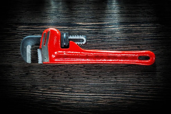 Pipe wrench on vintage wooden board — Stock Photo, Image