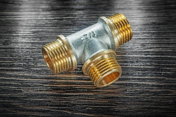 T-tube pipe connector on vintage wooden board — Stock Photo, Image