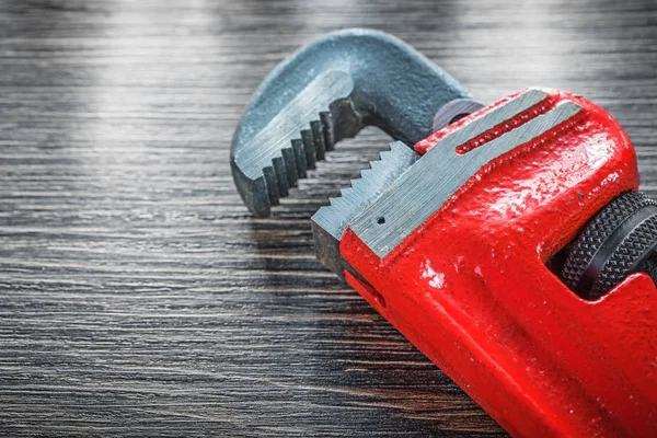 Plumbing adjustable wrench on vintage wooden board — Stock Photo, Image