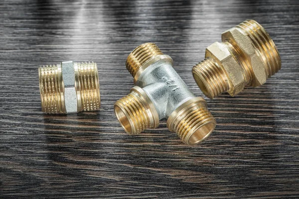 Plumbing brassware on vintage wooden board — Stock Photo, Image