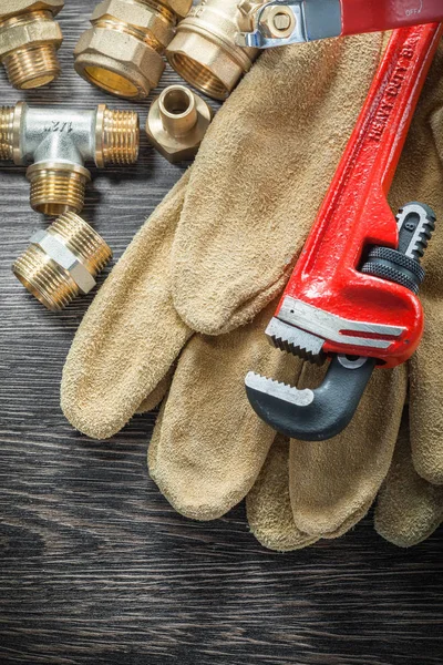 Plumbing monkey wrench pipe connectors protective gloves water v — Stock Photo, Image