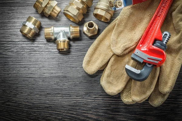 Plumbing monkey wrench pipe fittings protective gloves water val — Stock Photo, Image