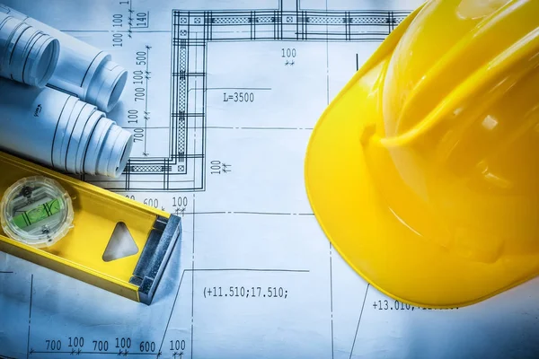 Building helmet construction level drawings on blueprint — Stock Photo, Image