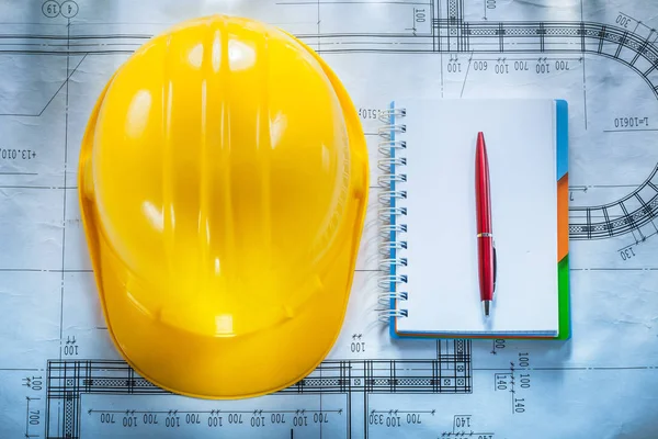 Protective building helmet notebook pen on blueprint — Stock Photo, Image