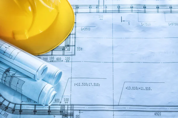 Protective hard hat construction drawings on blueprint — Stock Photo, Image