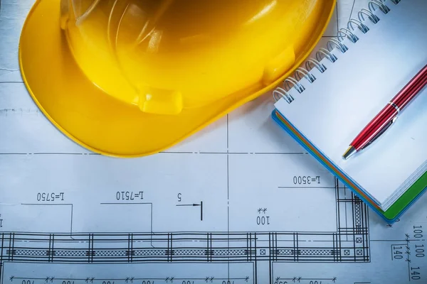 Safety building helmet notebook pen on blueprint — Stock Photo, Image