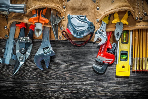 Correa de herramientas con herramientas de construcción en tablero de madera — Foto de Stock