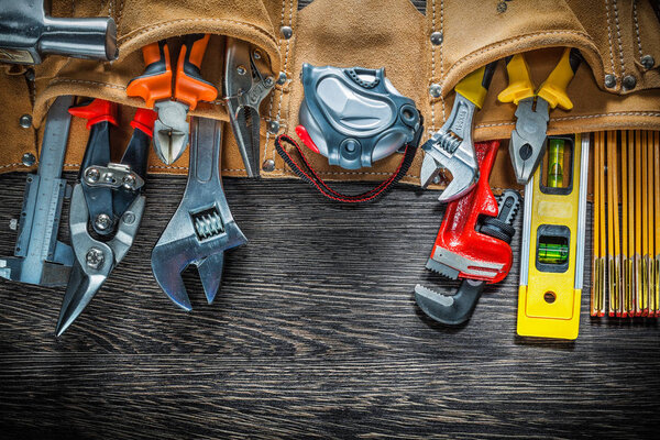 Tool belt with construction tooling on wooden board