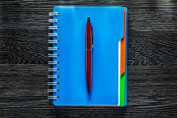Ballpoint pen notebook on vintage wooden board
